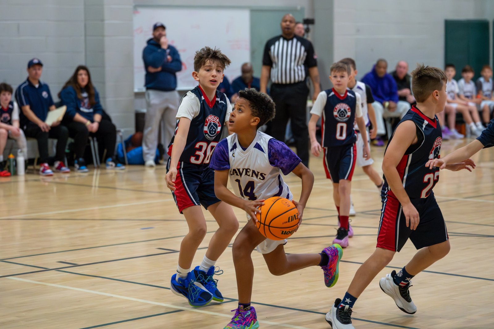 Youth basketball player driving to the hoop during a league game